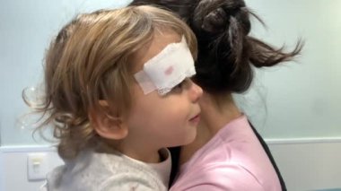 Hurt little boy at hospital with stictches after fall. Toddler infant with bandage needing medical intervention 