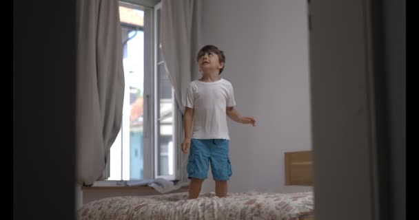 Young Boy Jubilantly Leaping Bed 800 Fps Speed Ramped Ultra — Stock Video