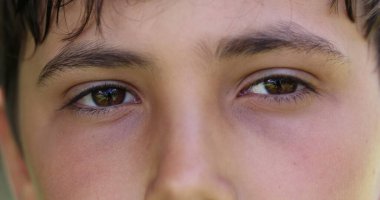 Pensive young boy closing eyes in contemplation. Thoughtful child thinking with eyes closed