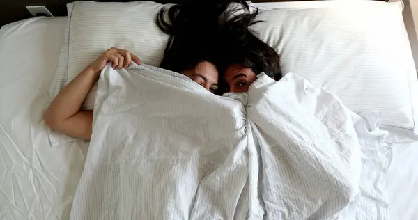 Fun Loving Young Married Couple Hiding Blanket Bed Top View — Zdjęcie stockowe