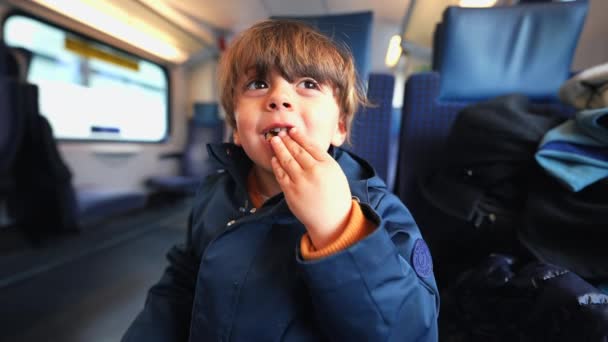 Caucasian Boy Seated Train Relishing Butter Biscuit Indulging Cookie Treat — Stock Video