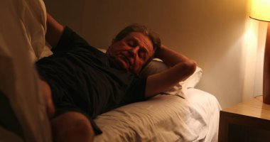Senior man suffering form insomnia unable to sleep