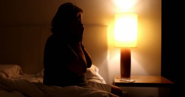 Troubled senior unable to sleep. Anxious older woman awake in the middle of the night suffering
