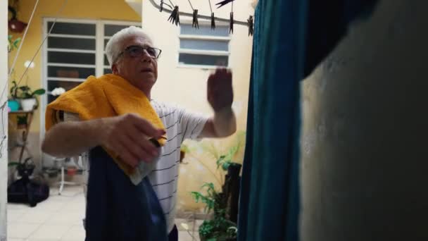 Senior Citizen Tending Laundry Backyard Retired Individual Handling Towels Suburban — Stock Video