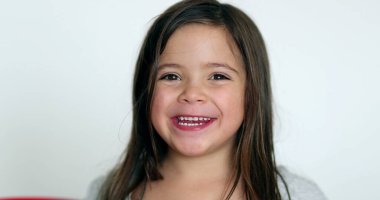 Happy little girl smiling at camera. Cute adorable child portrait face