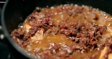 Cooking osso buco meet inside pan. braised veal food close-up