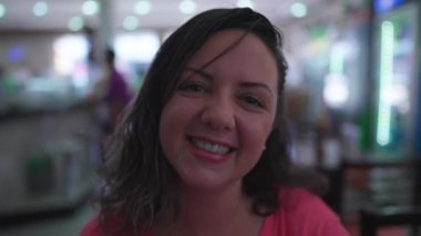 Kameraya gülümseyen mutlu genç bir kadının portresi, Kafeterya 'nın içinde yakın plan