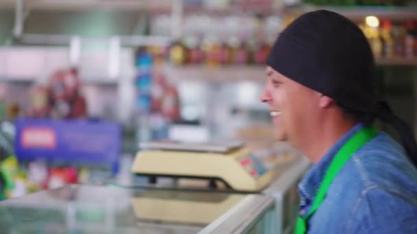 カフェテリア ワーカーがお客様と交流し カウンターの裏で食品の注文を受ける 女性のクライアントは笑って笑う — ストック動画