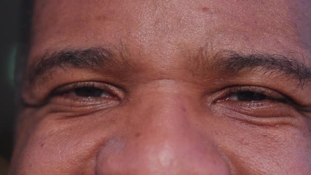 幸せな黒人男性の目が微笑んでいるマクロ 30代の喜びに満ちたアフリカ系アメリカ人の極端な詳細 — ストック動画