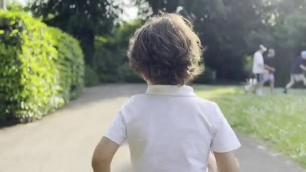 Boy Runs Ahead Mother Sunlit Park Authentic Motherhood Scenes Everyday — Stock Video