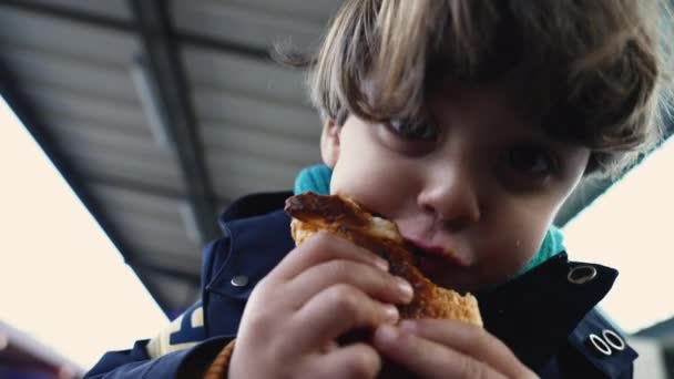Portrait Delighted Child Wide Smile Eating Croissant Train Platform Autumn — Stock Video