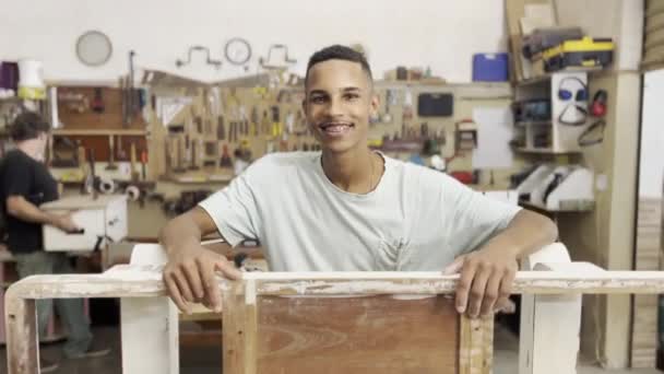 Smiling Young Black Woodworking Assistant Amidst Wood Pieces Tools — Stock Video