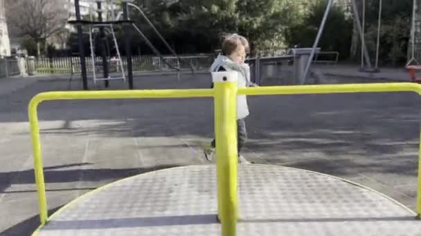 Playful Carousel Adventure Boy Starts Carousel Motion Jump Sunny Playground — Stock Video