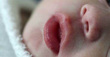closeup of newborn baby mouth in macro