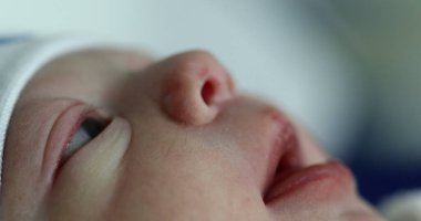 Baby newborn face in first minutes of life
