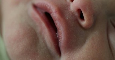 Closeup macro of newborn infant baby opening mouth