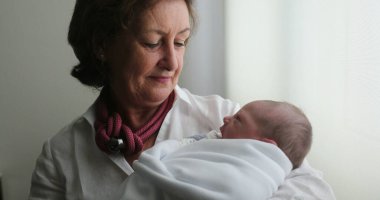 Grand-mother holding newborn baby