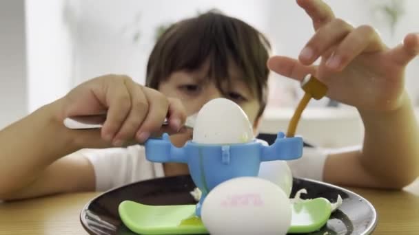 Breakfast Fun Boy Cracks Eggshell Spoon Playful Egg Holder Home — Stock Video