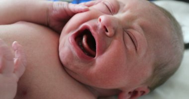 Portrait of newborn infant baby first hours of life at hospital