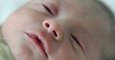 Portrait of newborn baby face in first day of life