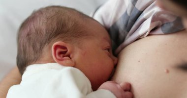 Mother breastfeeding infant newborn baby
