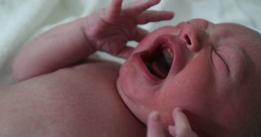 Newborn baby crying at hospital, first minutes of life