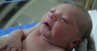 Newborn baby infant at hospital in first hours of life