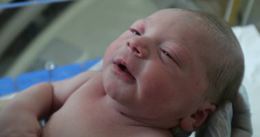 Newborn baby infant at hospital in first hours of life