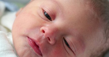 Newborn baby infant face in first day of life