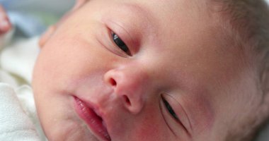 Newborn baby infant face in first day of life