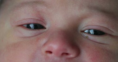 Newborn closeup of baby eyes, first day of life