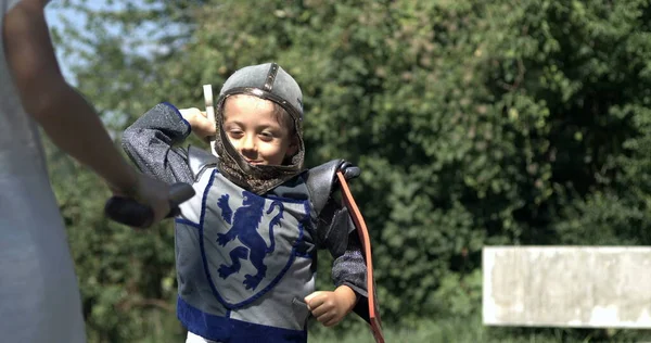 Child in Period Costume Engaging in Swordplay Captured