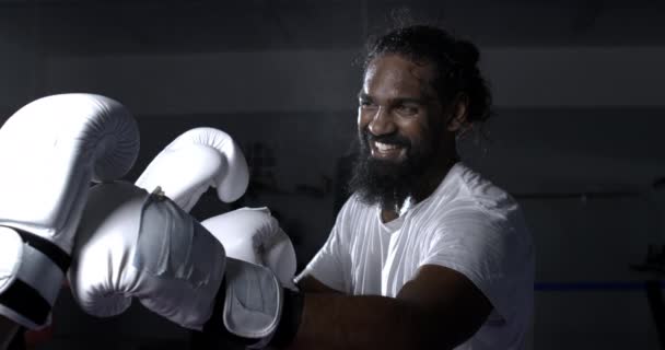 一名快乐的年轻黑人拳击手戴着拳击手套微笑着在拳击场内与对手交锋 — 图库视频影像