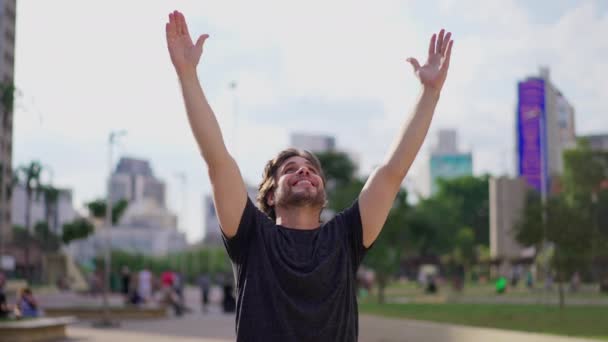 Exultant Young Man Expressing Hope Faith Uplifted Arms Celebrating Triumph — Stock Video