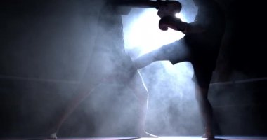 Boks ringinde karşı karşıya olan iki boksör, spot ışıklarıyla 800 fps 'te yavaş çekimde çarpıcı bir şekilde yankılanıyor. Rakip yüz yüze.