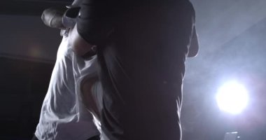 Rakibi diziyle tekmeleyen dövüşçü 800 fps 'te süper yavaş çekimde, savaşçı boks ringinde çarpıcı bir şekilde birbiriyle dövüşüyor.