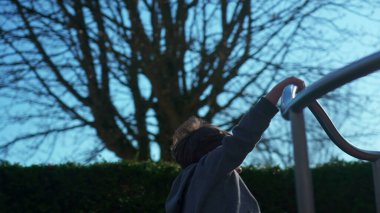 Küçük çocuk hoş bir şekilde döner döner döner döner döner, enerjik çocuk kaygısız bir şekilde eğlenir. Çocuk oyun sahasındaki atlıkarıncada neşeyle oynuyor.