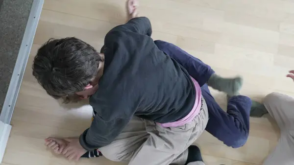 Stock image Brotherly Battle, Siblings Engaging in Floor Wrestling and Quarreling. Sibling Rivalry, Brothers Wrestling on Floor in Spirited Quarrel