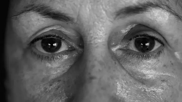 Monochrome Intimate Elderly Glimpse - Macro View of Senior Woman Face and Eyes