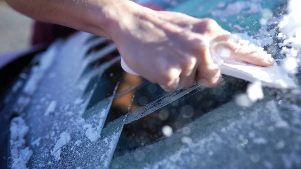 Woman Deicing Side Car Windshield With Scraper Stock Photo