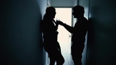 Angry parents fighting in front little boy son. Abusive relationship discussion. Husband hitting wife standing in corridor in the dark