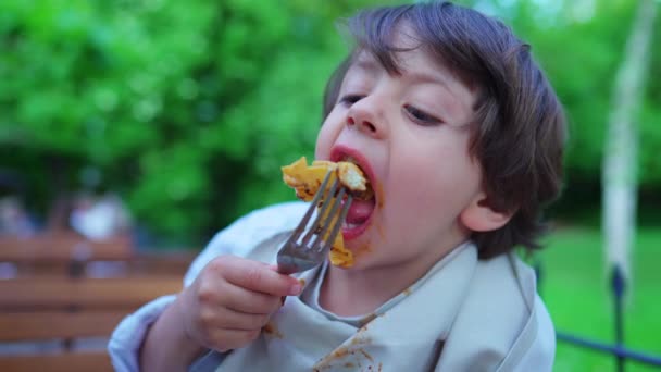 Messy Small Boy Eating Pasta Lunch Outdoors Sunny Setting Portrait — Stock Video