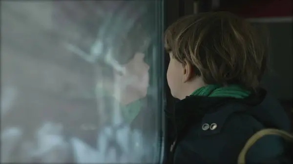 Little Boy by Train Window Observing as it Enters Tunnel, Child Passenger on High-Speed Journey