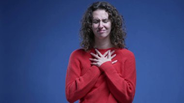 Minnettar kadın ellerini göğsüne koydu. Minnettarlığını ve inancını mavi arka planda hissetti.