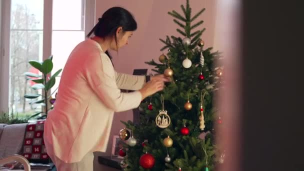 Candid Woman Decorating Christmas Tree Holiday Season December Home Authentic — Stock Video