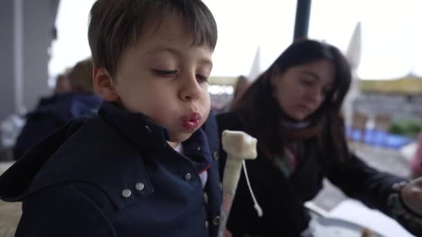 Child Cooling Hot Swiss Fondue Eating Outdoor Restaurant Mom — Stock Video