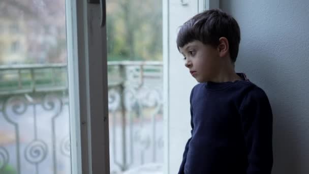 Introspektiva Barn Står Vid Fönstret Blickar Från Lägenheten Med Ledsen — Stockvideo