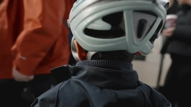 Back Child Watching Passengers Exit Train Waiting Board Wearing Helmet — Stock Video