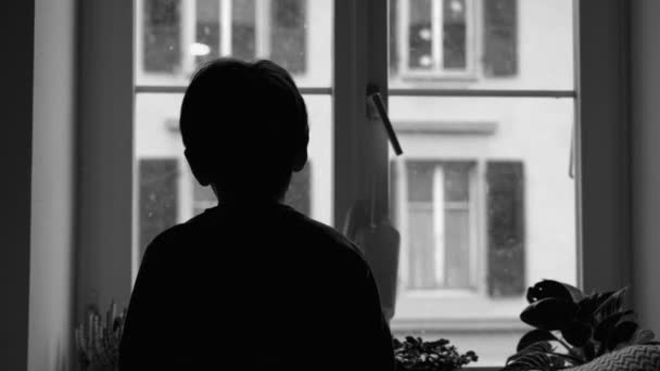 Back Sad Depressed Child Staring Snow Fall Apartment Window Pensive — Stock Video