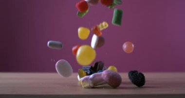Sweet Candies Falling in Super Slow Motion on Pink Background